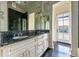 Bathroom featuring dual sinks, granite countertops, and access to a balcony at 1040 W Conway Nw Dr, Atlanta, GA 30327