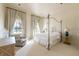 Bedroom featuring a canopy bed, large windows with curtains, and carpeted floors at 1040 W Conway Nw Dr, Atlanta, GA 30327