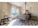 Bright bedroom featuring canopy bed, patterned rug, and scenic views at 1040 W Conway Nw Dr, Atlanta, GA 30327