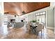 Bright open-concept dining room with access to living room, fireplace, and elegant chandelier at 1040 W Conway Nw Dr, Atlanta, GA 30327