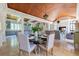 Elegant dining room with wood ceiling, chandelier, kitchen access, and open to the living area at 1040 W Conway Nw Dr, Atlanta, GA 30327