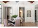 Open-concept dining room featuring a glass table, pink upholstered chairs, and access to other rooms at 1040 W Conway Nw Dr, Atlanta, GA 30327