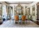 Dining room featuring ornate decor, mirrored walls, and seating for six around a marble table at 1040 W Conway Nw Dr, Atlanta, GA 30327