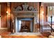 Ornate fireplace featuring an elaborate mantel, stone hearth, and decorative tools at 1040 W Conway Nw Dr, Atlanta, GA 30327