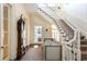 Light-filled foyer with grand staircase and antique clock at 1040 W Conway Nw Dr, Atlanta, GA 30327