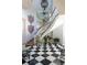 Elegant foyer with a grand staircase, checkered floor, statue, and decorative accents at 1040 W Conway Nw Dr, Atlanta, GA 30327