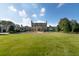 Expansive front yard featuring a meticulously maintained lawn and impressive stately home in the background at 1040 W Conway Nw Dr, Atlanta, GA 30327