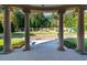 Elegant colonnade frames a view of manicured grounds with a stone wall, fountain, and play area at 1040 W Conway Nw Dr, Atlanta, GA 30327