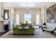 Bright living room with high ceilings, a fireplace, large windows, and stylish furnishings at 1040 W Conway Nw Dr, Atlanta, GA 30327