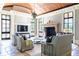 Bright living room with a stone fireplace, wooden ceiling, and open to patio through french doors at 1040 W Conway Nw Dr, Atlanta, GA 30327