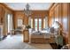 Main bedroom featuring wood paneled walls, fireplace, and elegant chandelier at 1040 W Conway Nw Dr, Atlanta, GA 30327