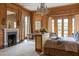 Luxury main bedroom features wood paneled walls, fireplace, and large windows at 1040 W Conway Nw Dr, Atlanta, GA 30327