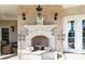 Charming outdoor fireplace with brick surround, decorative mantle, sconces, and a cozy seating area at 1040 W Conway Nw Dr, Atlanta, GA 30327