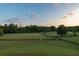 Picturesque view of fenced pastures with lush green grass and mature trees, perfect for equestrian activities at 1040 W Conway Nw Dr, Atlanta, GA 30327
