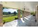 Elegant outdoor patio with stone flooring, brick columns, ceiling fans, and views of the expansive pasture at 1040 W Conway Nw Dr, Atlanta, GA 30327