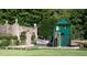 Charming playground area with a multi-level playhouse, slide, trampoline, and manicured landscaping at 1040 W Conway Nw Dr, Atlanta, GA 30327