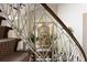 Staircase featuring a decorative metal railing with a glimpse into the dining room in the background at 1040 W Conway Nw Dr, Atlanta, GA 30327
