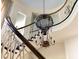 Elegant staircase with ornate metalwork railing and balloon-shaped chandelier enhancing the home's design at 1040 W Conway Nw Dr, Atlanta, GA 30327