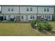 Backyard view of the townhome with a grassy lawn and small patio area, perfect for outdoor entertaining at 1312 Cooper Springs Rd, Grayson, GA 30017