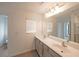 Bathroom featuring double sink vanity with a large mirror and modern fixtures at 1312 Cooper Springs Rd, Grayson, GA 30017