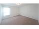 A carpeted bedroom featuring a bright window and neutral paint at 1312 Cooper Springs Rd, Grayson, GA 30017