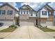 Charming townhome showcasing brick and siding facade with a private two-car garage and meticulously manicured front yard at 1312 Cooper Springs Rd, Grayson, GA 30017