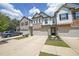 Attractive townhome featuring brick and siding with a two-car garage and lush landscaping enhancing the curb appeal at 1312 Cooper Springs Rd, Grayson, GA 30017