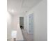 Bright hallway with stairs leading up to the bedrooms and a bathroom located off the hall at 1312 Cooper Springs Rd, Grayson, GA 30017