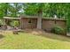 A brick house with a pergola sitting on a well maintained lawn at 3517 Greenway Dr, Marietta, GA 30008