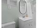 Clean bathroom with a modern vanity, sleek mirror, and a shower with a crisp, white shower curtain at 3517 Greenway Dr, Marietta, GA 30008