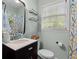 Stylish bathroom featuring a sleek vanity, decorative mirror, and shower with elegant fixtures at 3517 Greenway Dr, Marietta, GA 30008