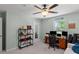 Well-lit bedroom featuring neutral walls, ceiling fan, and a functional workspace near a bright window at 3517 Greenway Dr, Marietta, GA 30008
