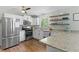 Modern kitchen featuring stainless steel appliances, granite counters, and floating shelves at 3517 Greenway Dr, Marietta, GA 30008
