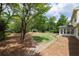 Large, fenced backyard with mature trees, stone pathways, and a sunroom at 4085 Chadds Walk, Marietta, GA 30062