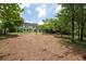 Expansive backyard with lush greenery, mature trees, and a multi-story home in the background at 4085 Chadds Walk, Marietta, GA 30062
