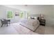 Spacious and brightly lit bedroom featuring a cushioned headboard, and large windows providing lots of natural light at 4085 Chadds Walk, Marietta, GA 30062