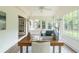 Bright sun room with a desk, cozy chair, and windows that offer natural light and views of the surrounding greenery at 4085 Chadds Walk, Marietta, GA 30062