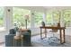 Bright sunroom featuring large windows, a comfortable chair, and a desk at 4085 Chadds Walk, Marietta, GA 30062