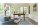 Bright sunroom featuring large windows, a comfortable chair, and a work desk at 4085 Chadds Walk, Marietta, GA 30062