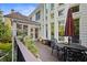 Back deck with black metal furniture, potted plants, and views to yard and property at 4731 Moon Chase Dr, Buford, GA 30519