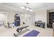 Spacious finished basement with gym equipment, lighting and a view to other areas at 4731 Moon Chase Dr, Buford, GA 30519