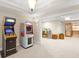 Spacious basement with carpeting, featuring two retro arcade games, and views into an adjacent room at 4731 Moon Chase Dr, Buford, GA 30519