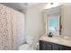 Bathroom features a toilet, vanity with sink and a shower/tub with a polka dot curtain at 4731 Moon Chase Dr, Buford, GA 30519