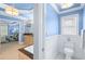 Bright primary bathroom with double vanity, tub, and toilet, leading to an adjacent bedroom at 4731 Moon Chase Dr, Buford, GA 30519