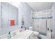Bathroom features a shower with glass doors, a toilet, a sink and decorative towels at 4731 Moon Chase Dr, Buford, GA 30519