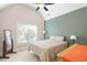 Bedroom with a green accent wall and angled ceilings, offering a modern aesthetic at 4731 Moon Chase Dr, Buford, GA 30519
