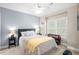 Comfortable bedroom with a ceiling fan and a side window, exuding a serene atmosphere at 4731 Moon Chase Dr, Buford, GA 30519