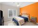 Bedroom with orange accent wall and large window providing ample natural light at 4731 Moon Chase Dr, Buford, GA 30519