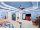 Spacious bedroom features a tray ceiling, seating area, and ample closet space with light blue paint at 4731 Moon Chase Dr, Buford, GA 30519