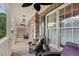 Inviting covered porch with seating area, brick flooring, and plenty of natural light, perfect for entertaining at 4731 Moon Chase Dr, Buford, GA 30519